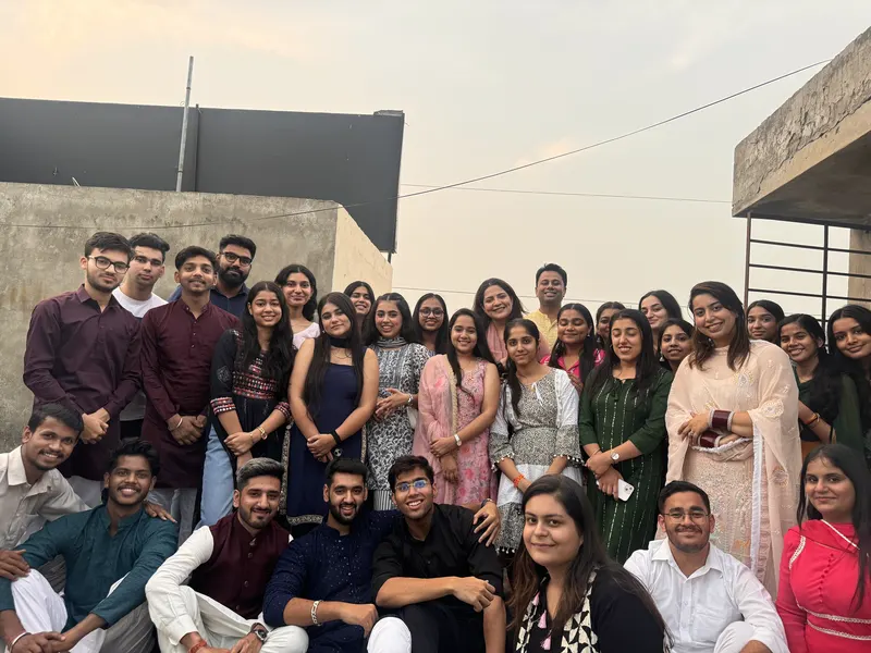 A closer rooftop group photograph in festive clothing