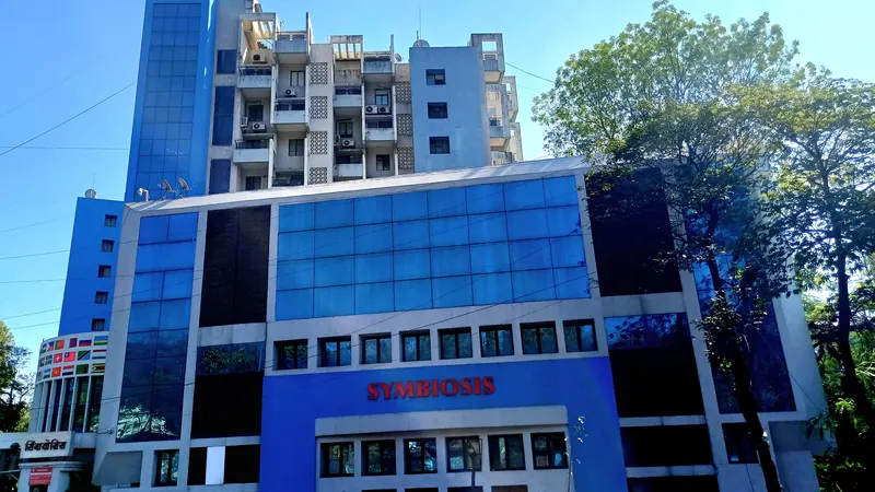 Symbiosis campus building on Senapati Bapat Road beneath green trees