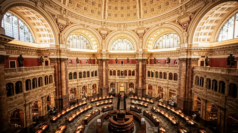 Circular library reading room beneath a richly decorated domed ceiling