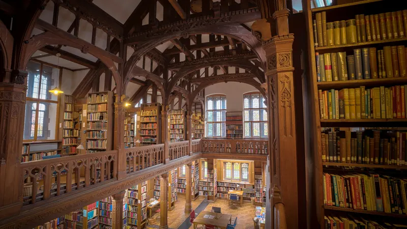 Wooden library galleries surrounding bookshelves beneath a high timber ceiling