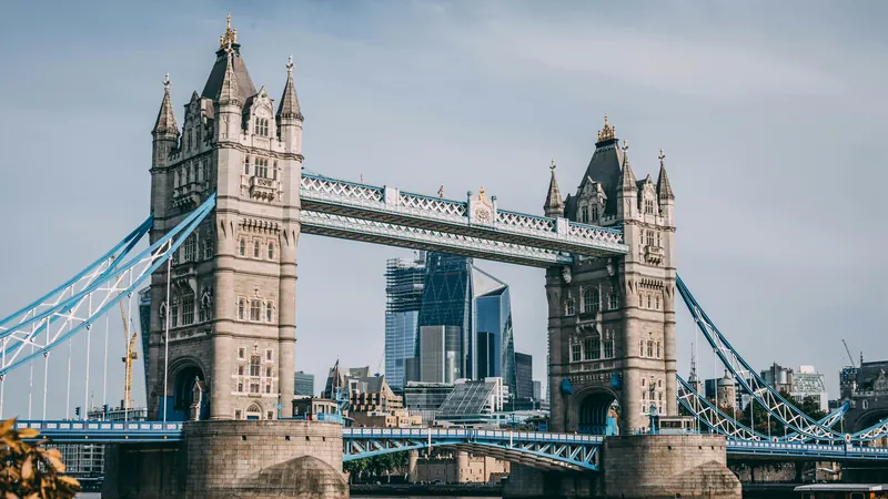 Two stone bridge towers linked by walkways above a river