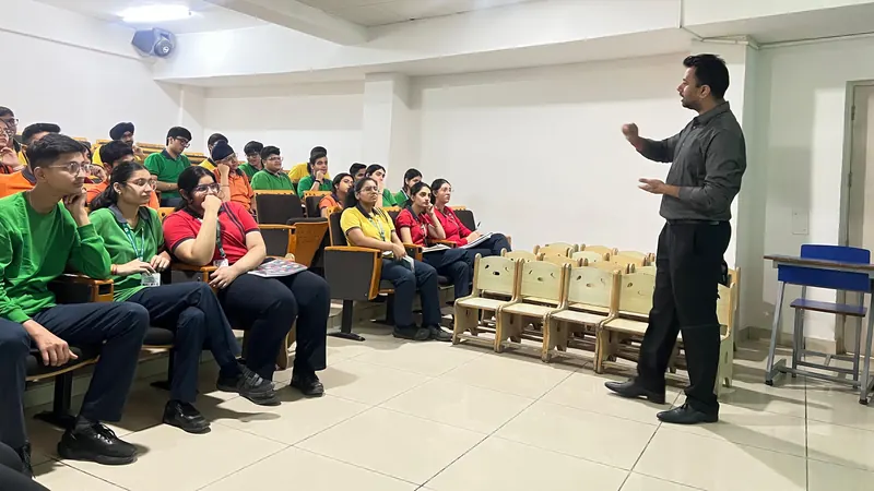 Anshul Wadhwa speaking to seated students