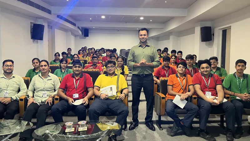 A group of seated students with Anshul Wadhwa standing among them